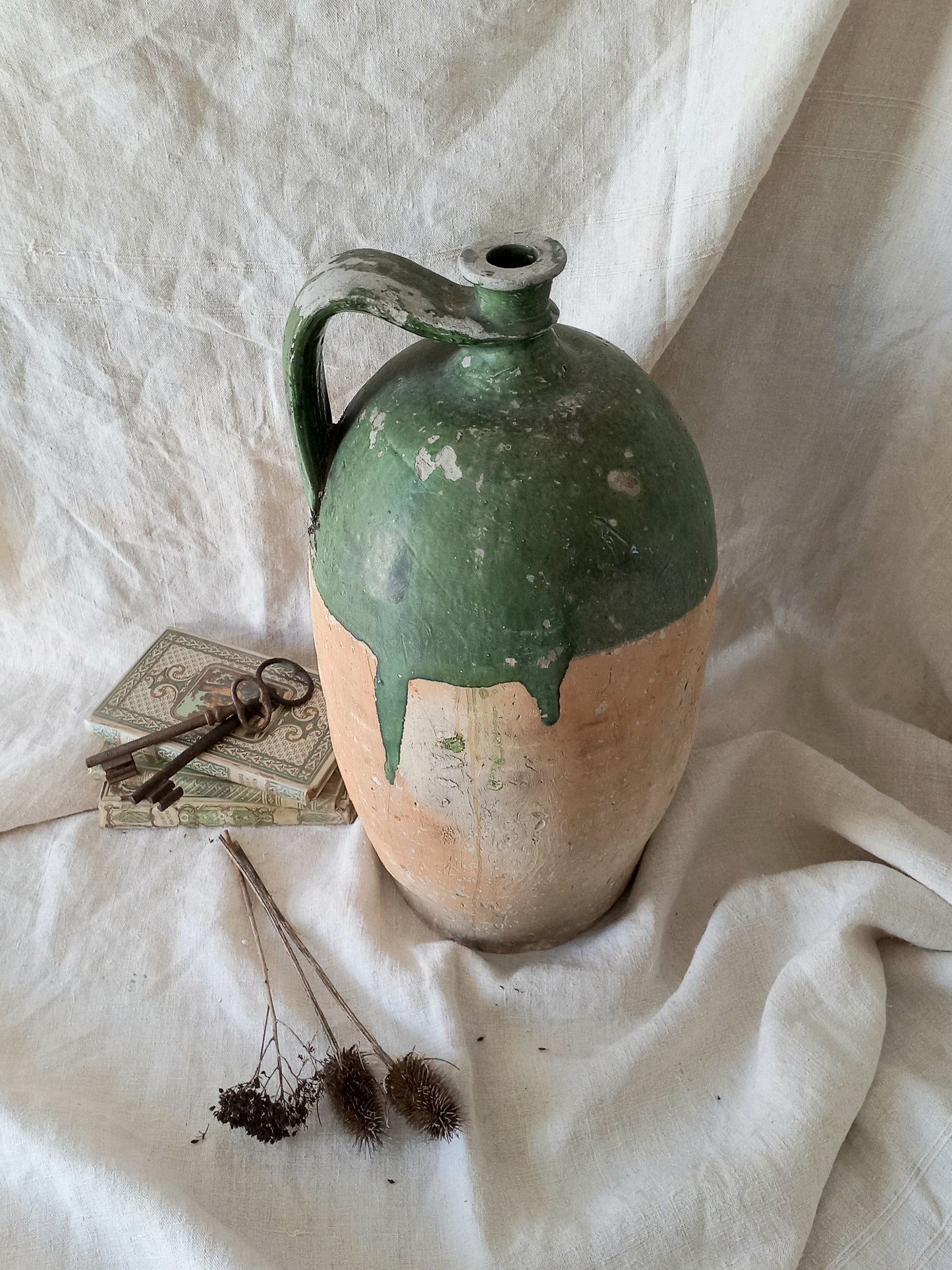 A rare and very large French antique stoneware preserving jar in a lovely shade of green over an earthy beige.