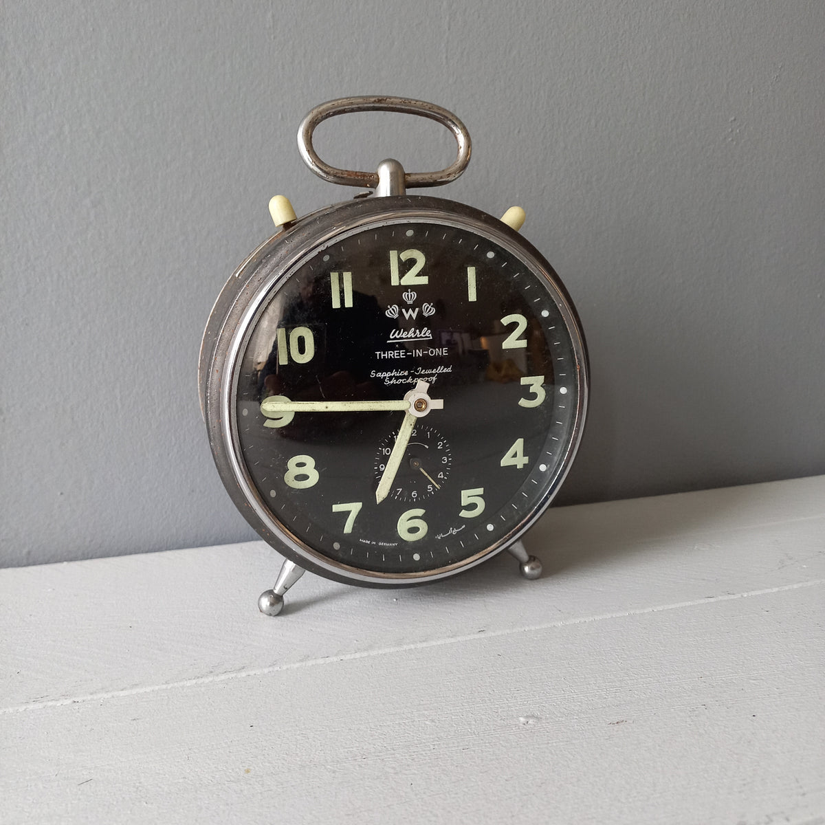 A large vintage mechanical alarm clock by German manufacturer Wehrle, a quality and heavy time-piece. A rare three-in-one clock in working condition including the chiming alarm - it can also sound on the hour and half hour. Gives a pleasing ticking sound and as you can see in the 4th photo, illuminates for a short time after lights out. The overall condition of the clock is used with obvious signs of age-related wear and rusty patina. Circa. 1960s/70s.