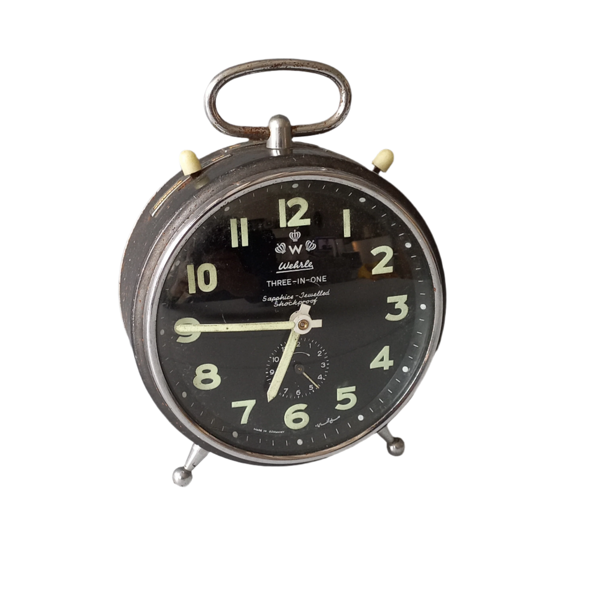 A large vintage mechanical alarm clock by German manufacturer Wehrle, a quality and heavy time-piece. A rare three-in-one clock in working condition including the chiming alarm - it can also sound on the hour and half hour. Gives a pleasing ticking sound and as you can see in the 4th photo, illuminates for a short time after lights out. The overall condition of the clock is used with obvious signs of age-related wear and rusty patina. Circa. 1960s/70s.