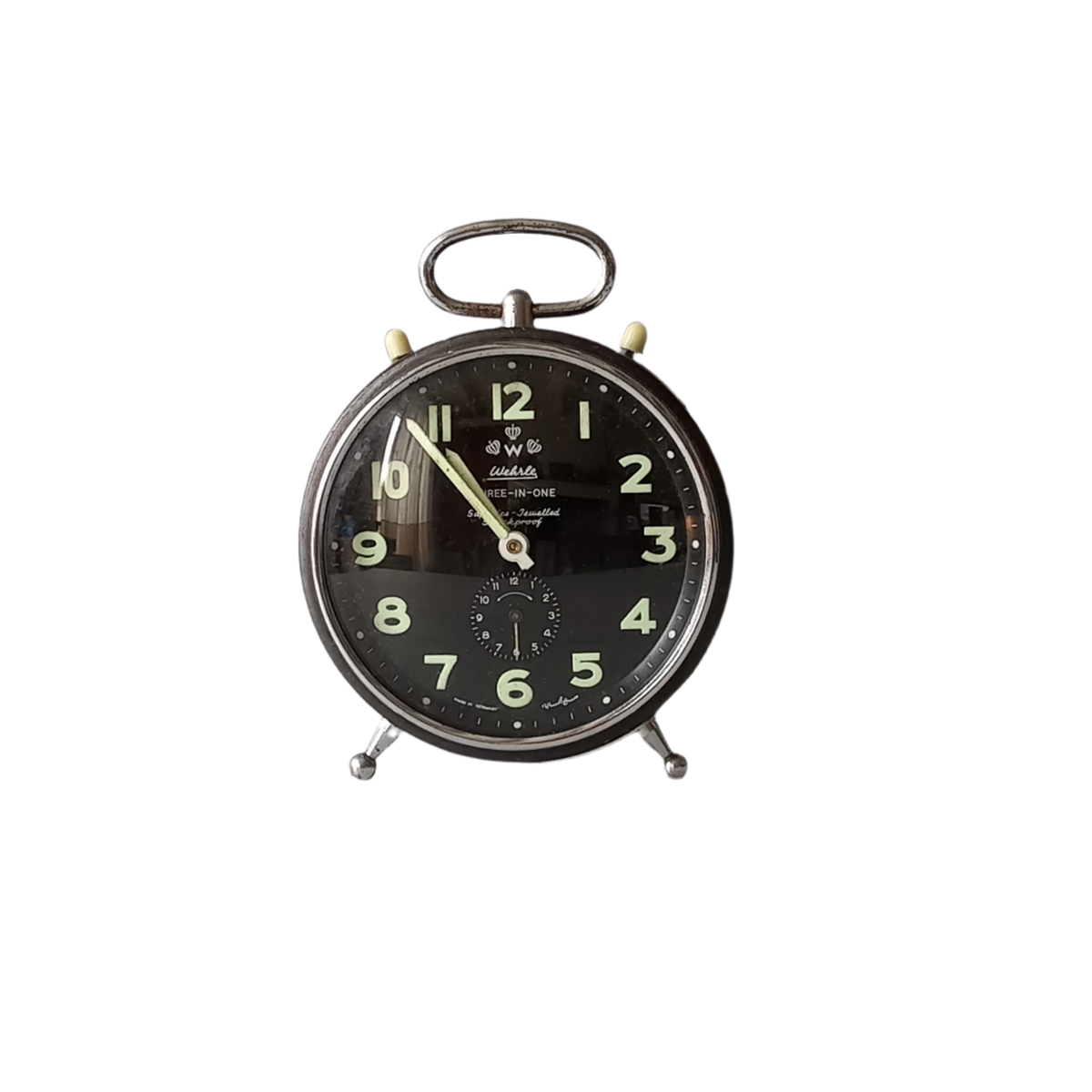 A large vintage mechanical alarm clock by German manufacturer Wehrle, a quality and heavy time-piece. A rare three-in-one clock in working condition including the chiming alarm - it can also sound on the hour and half hour. Gives a pleasing ticking sound and as you can see in the 4th photo, illuminates for a short time after lights out. The overall condition of the clock is used with obvious signs of age-related wear and rusty patina. Circa. 1960s/70s.
