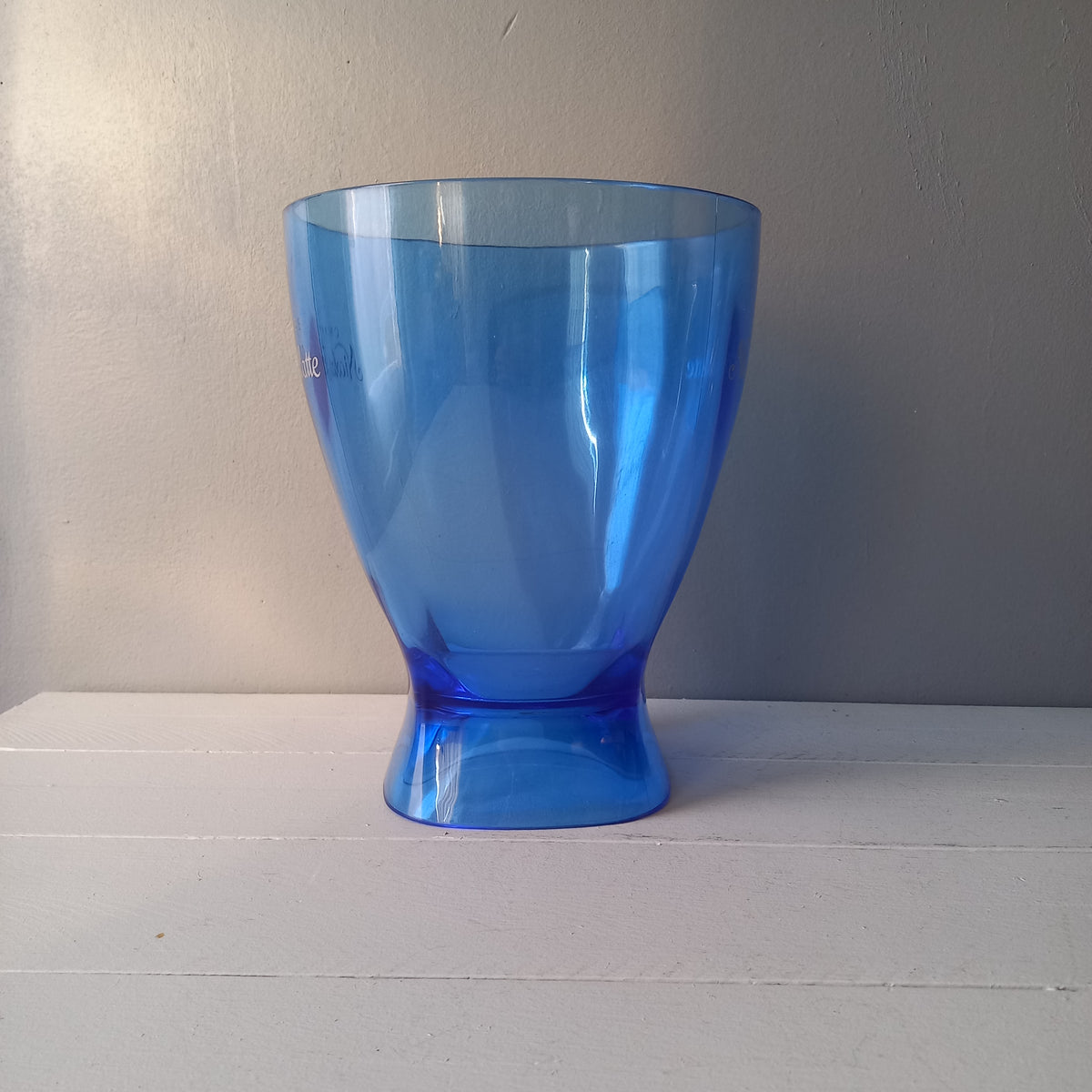 Vintage Nicolas Feuillatte transparent blue champagne bucket made from resin or hardened plastic. Being a vintage item there are of course some scuffs and scratches in the plastic.