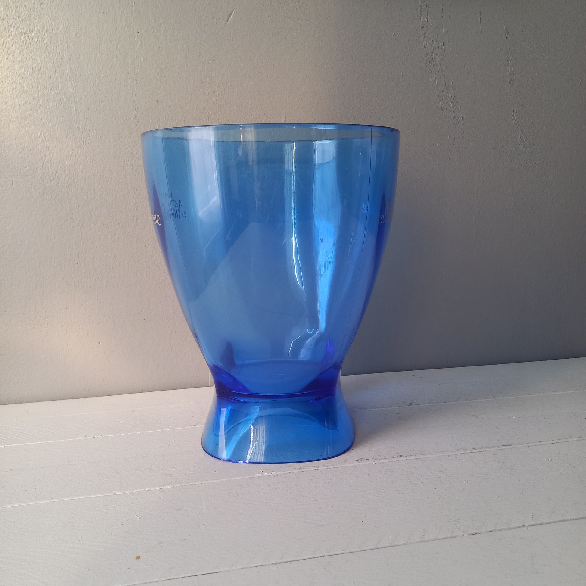Vintage Nicolas Feuillatte transparent blue champagne bucket made from resin or hardened plastic. Being a vintage item there are of course some scuffs and scratches in the plastic.