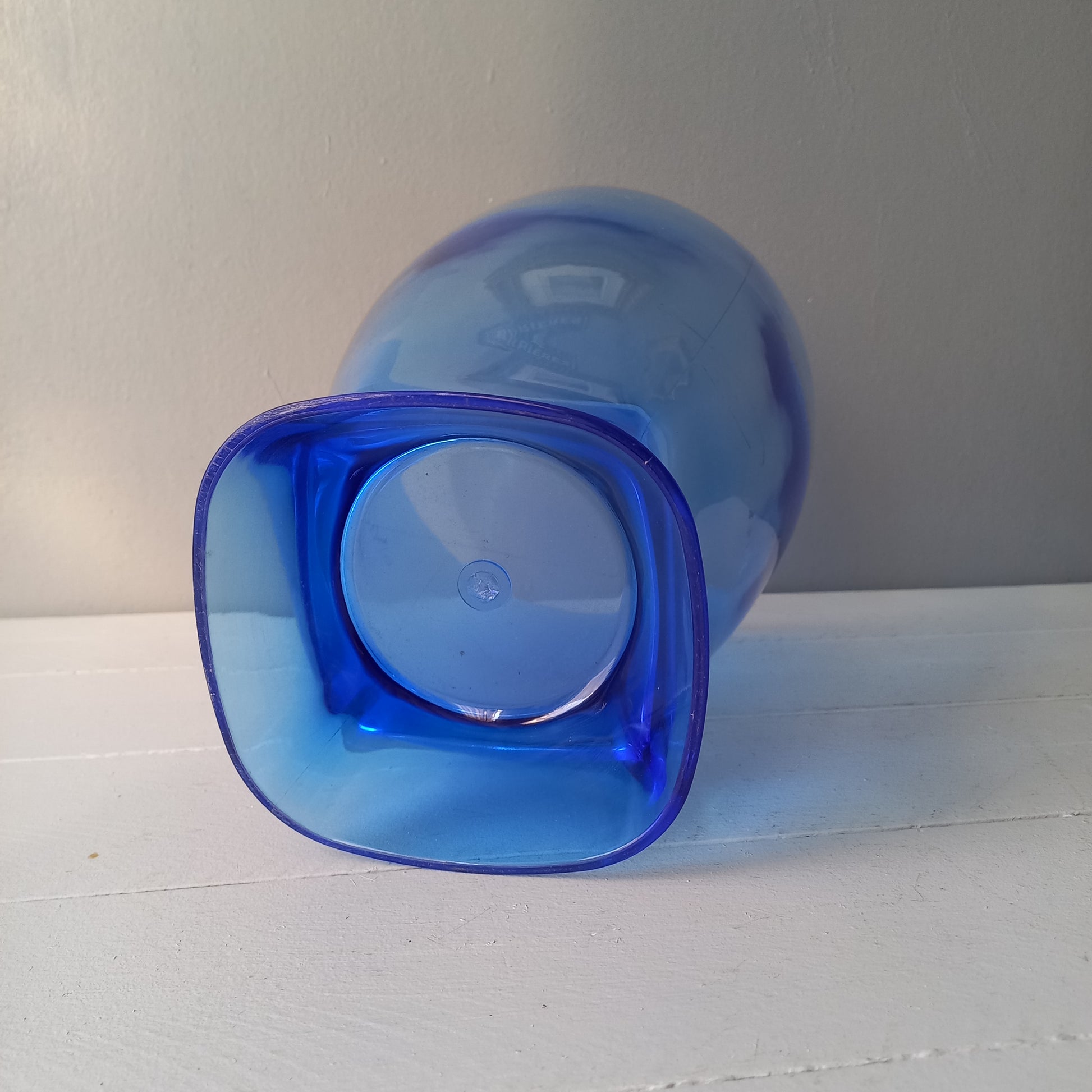 Vintage Nicolas Feuillatte transparent blue champagne bucket made from resin or hardened plastic. Being a vintage item there are of course some scuffs and scratches in the plastic.