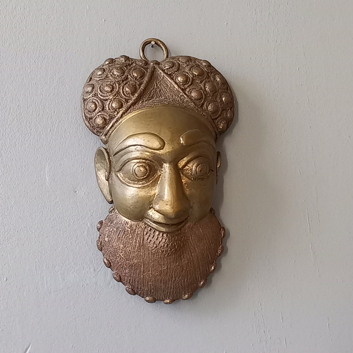An interesting little vintage tribal mask I purchased in France. It's a heavy, quality piece made from a brass-coated metal and would look great in an ethic mask collection or as a stand alone piece of wall decor.