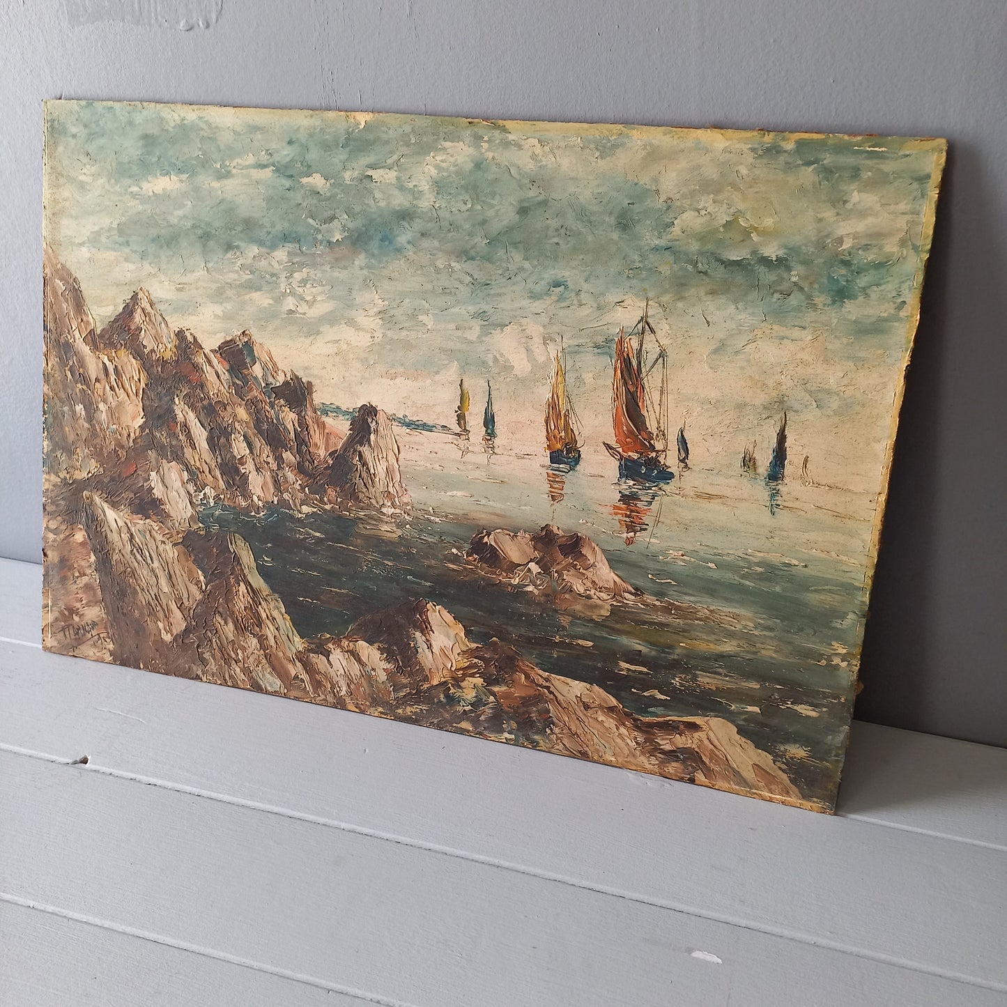 A beautiful piece of original French art depicting sailing boats on a rocky coastline. The painting is wonderfully done in a 'painterly' fashion with thick, vibrant oil paint strokes on hardboard. It has been signed and dated by the artist.