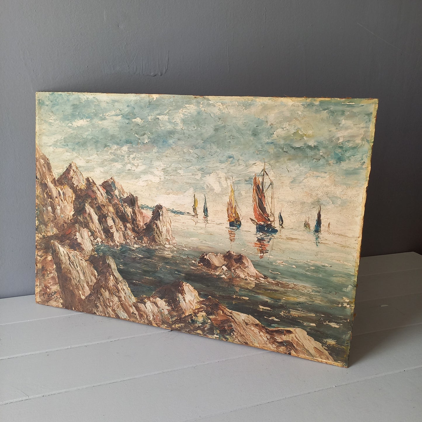 A beautiful piece of original French art depicting sailing boats on a rocky coastline. The painting is wonderfully done in a 'painterly' fashion with thick, vibrant oil paint strokes on hardboard. It has been signed and dated by the artist.
