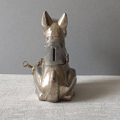 A fabulous French art deco metal terrier dog money box/coin storage box complete with a little padlock and key which still work. 

This unique piece of history was purchased in south west France and we can only imagine who once owned it and what they might have saved their coins to buy.