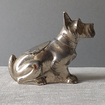 A fabulous French art deco metal terrier dog money box/coin storage box complete with a little padlock and key which still work. 

This unique piece of history was purchased in south west France and we can only imagine who once owned it and what they might have saved their coins to buy.