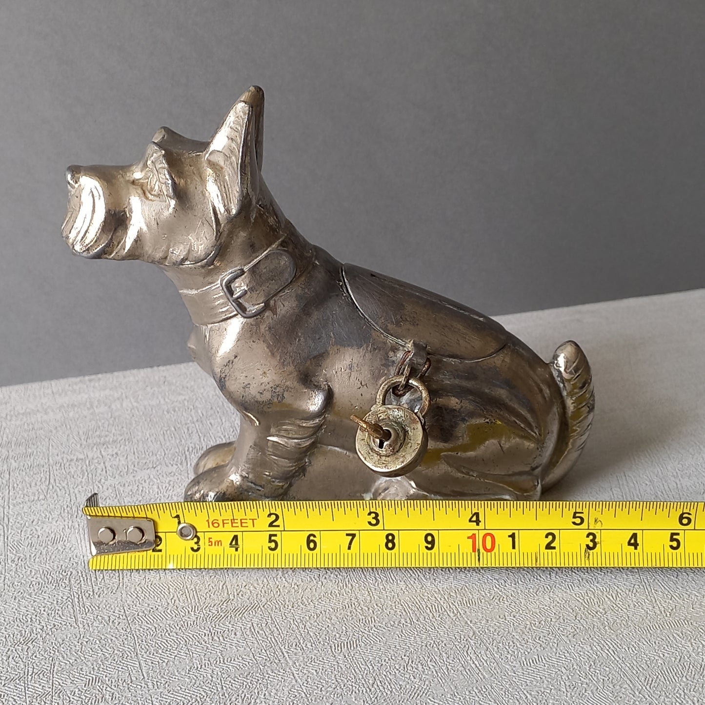 A fabulous French art deco metal terrier dog money box/coin storage box complete with a little padlock and key which still work. 

This unique piece of history was purchased in south west France and we can only imagine who once owned it and what they might have saved their coins to buy.