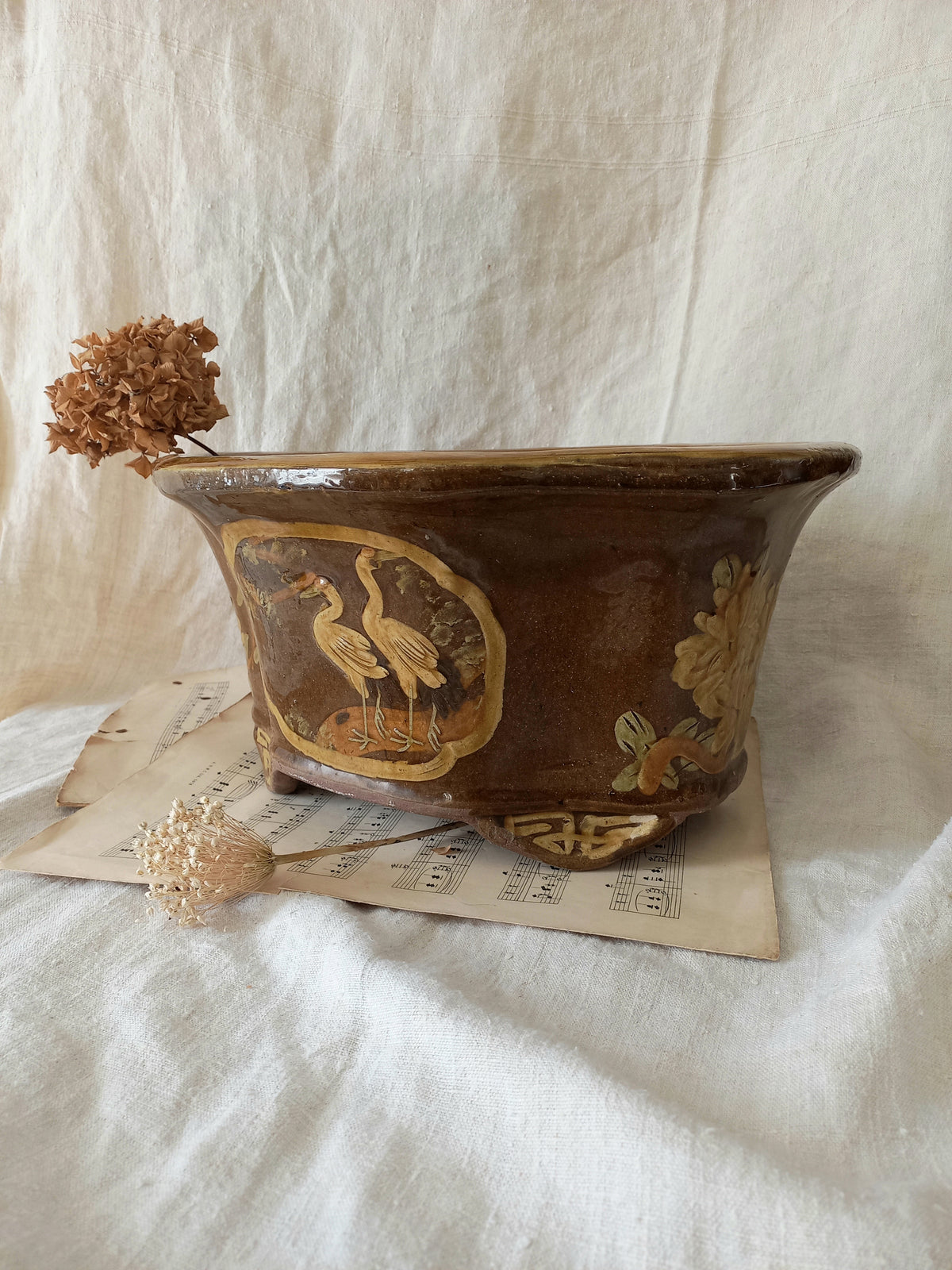 A stunning decorative glazed stoneware planter with oriental animal and floral design influences. 