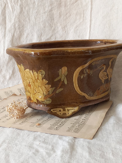 A stunning decorative glazed stoneware planter with oriental animal and floral design influences. 