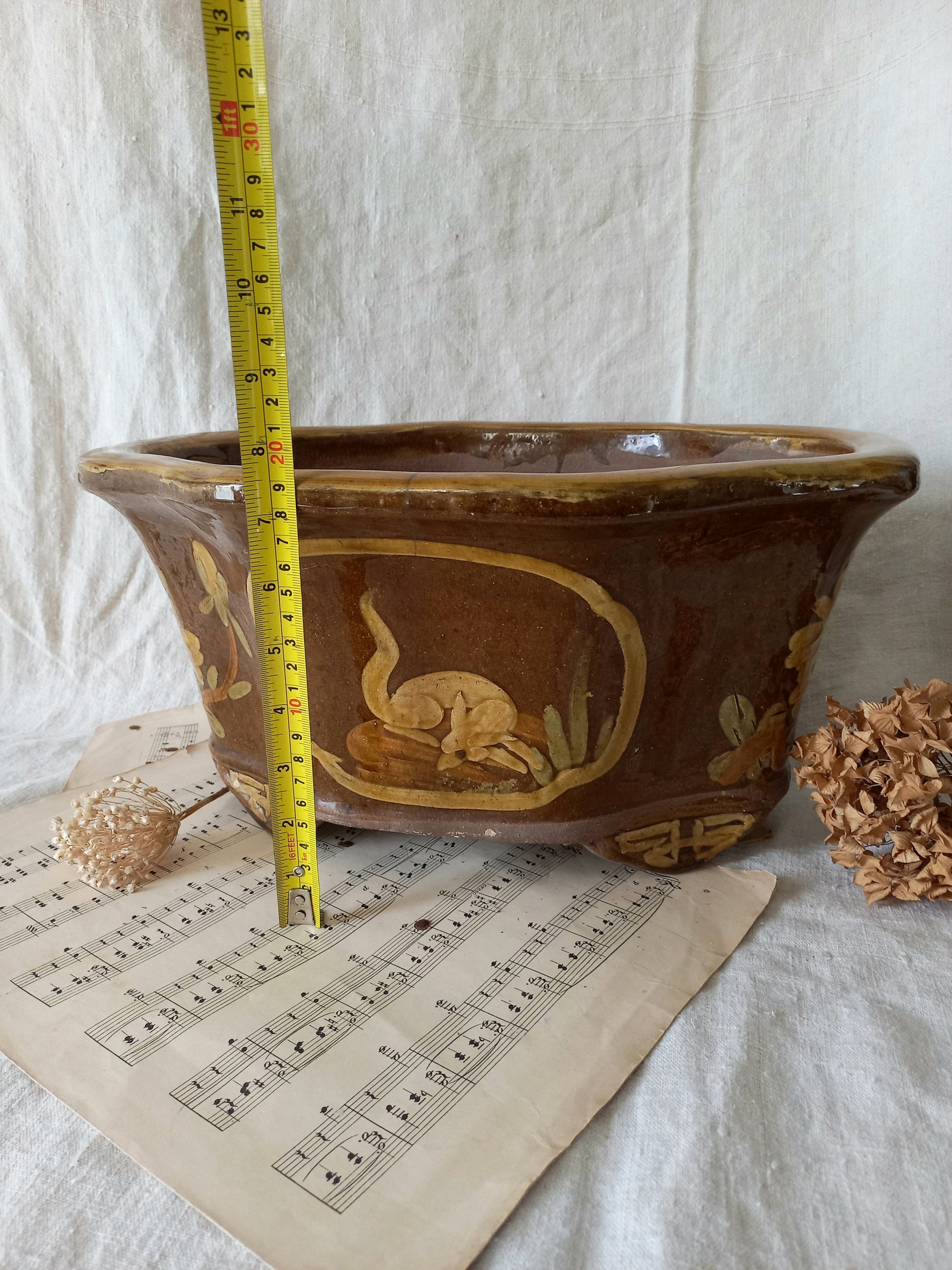 A stunning decorative glazed stoneware planter with oriental animal and floral design influences. 