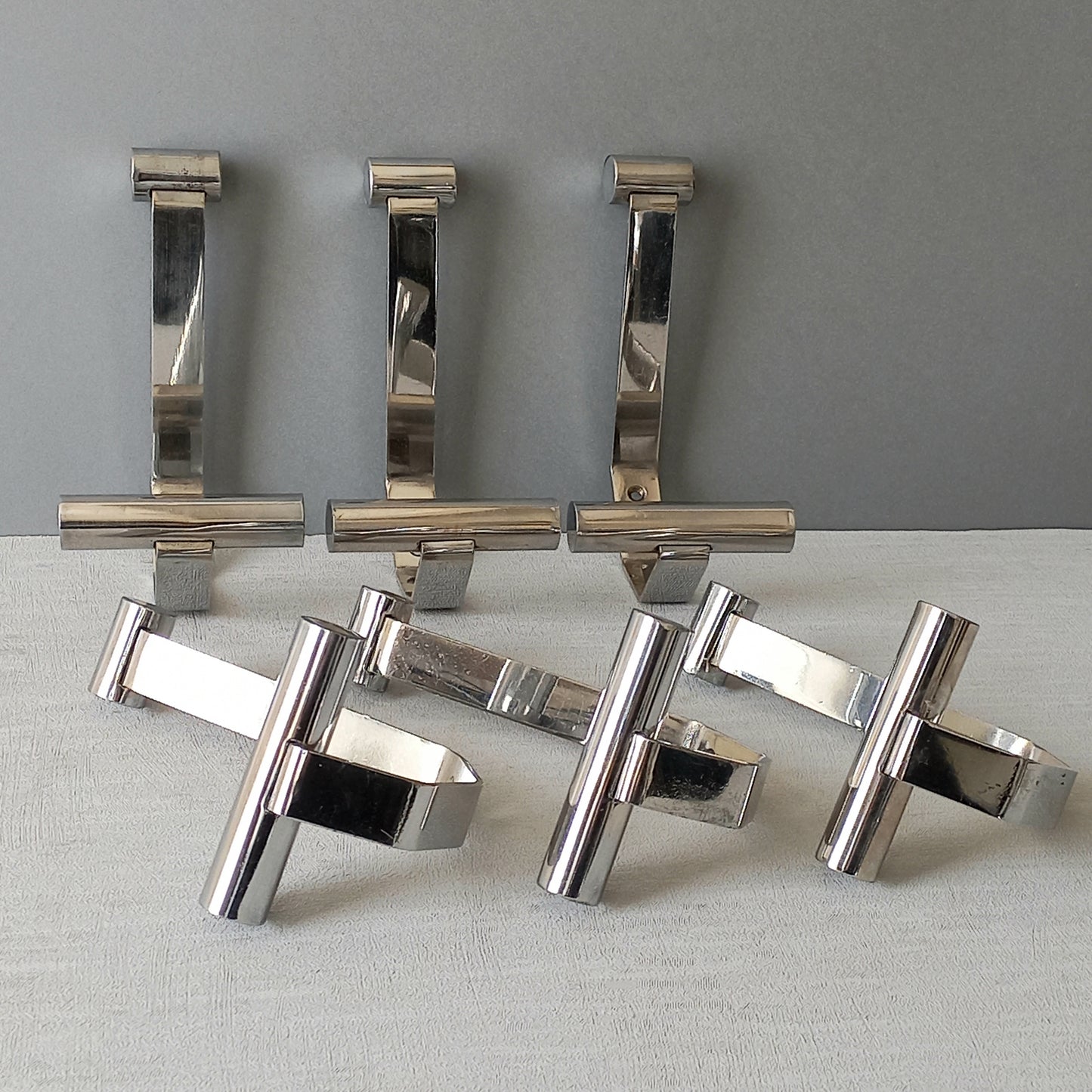 Set of 6 French vintage mid-century coat and hat hooks made from polished metal that can be simply fitted to your wall using the mounting holes.