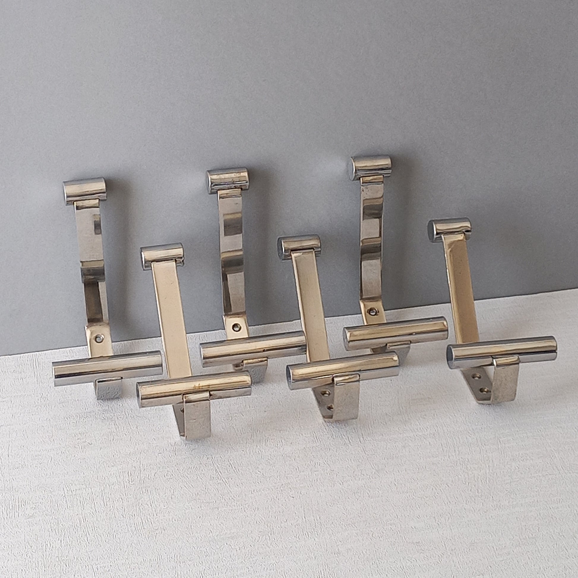 Set of 6 French vintage mid-century coat and hat hooks made from polished metal that can be simply fitted to your wall using the mounting holes.