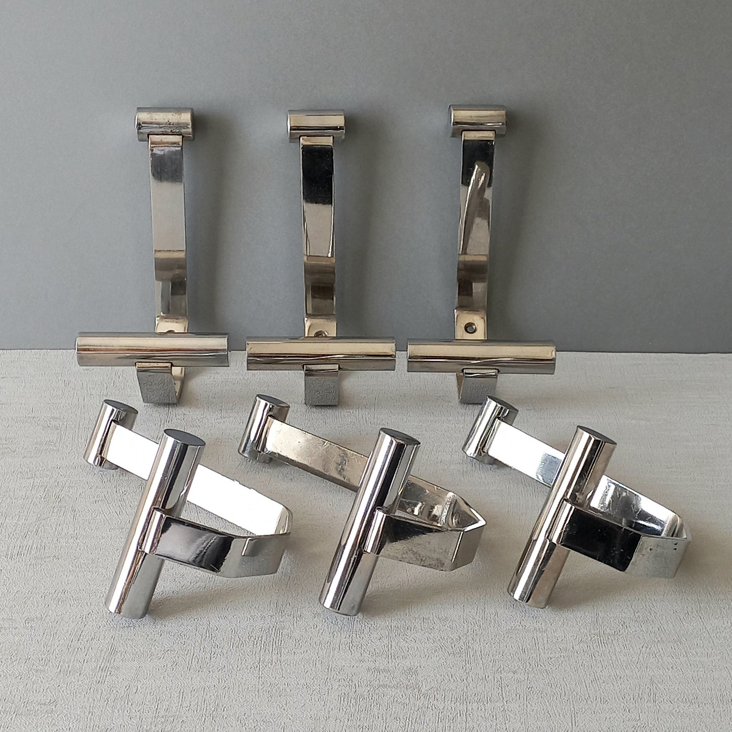 Set of 6 French vintage mid-century coat and hat hooks made from polished metal that can be simply fitted to your wall using the mounting holes.