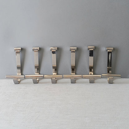 Set of 6 French vintage mid-century coat and hat hooks made from polished metal that can be simply fitted to your wall using the mounting holes.