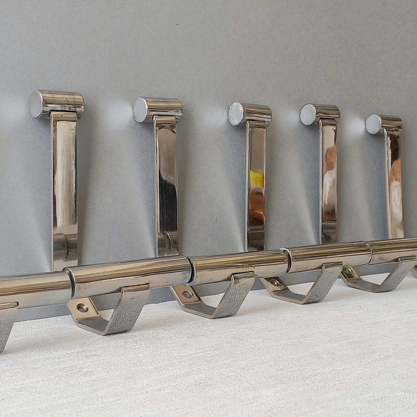 Set of 6 French vintage mid-century coat and hat hooks made from polished metal that can be simply fitted to your wall using the mounting holes.