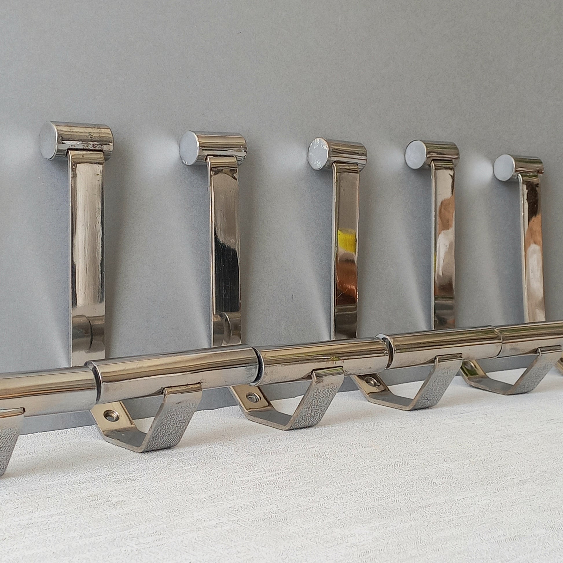Set of 6 French vintage mid-century coat and hat hooks made from polished metal that can be simply fitted to your wall using the mounting holes.