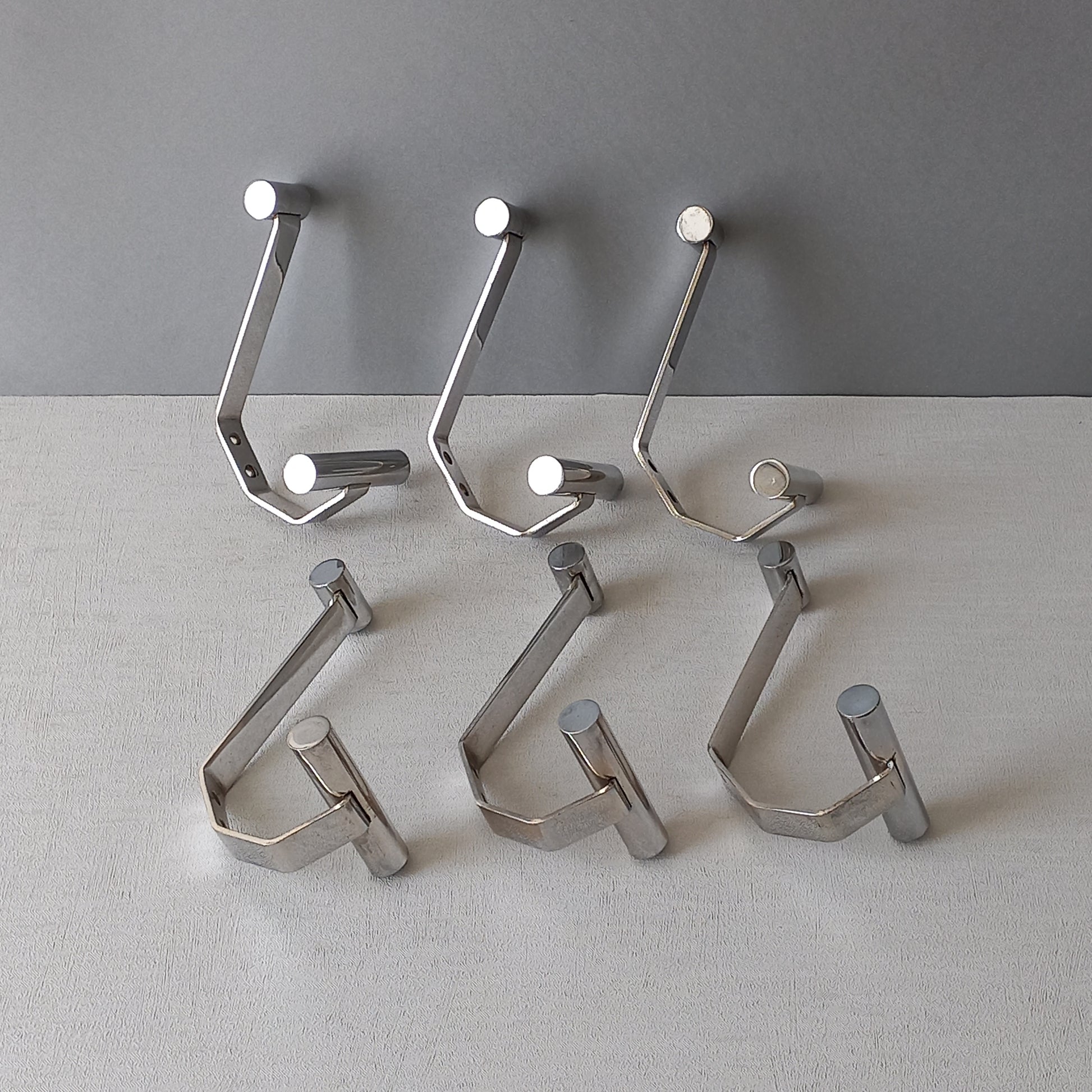 Set of 6 French vintage mid-century coat and hat hooks made from polished metal that can be simply fitted to your wall using the mounting holes.