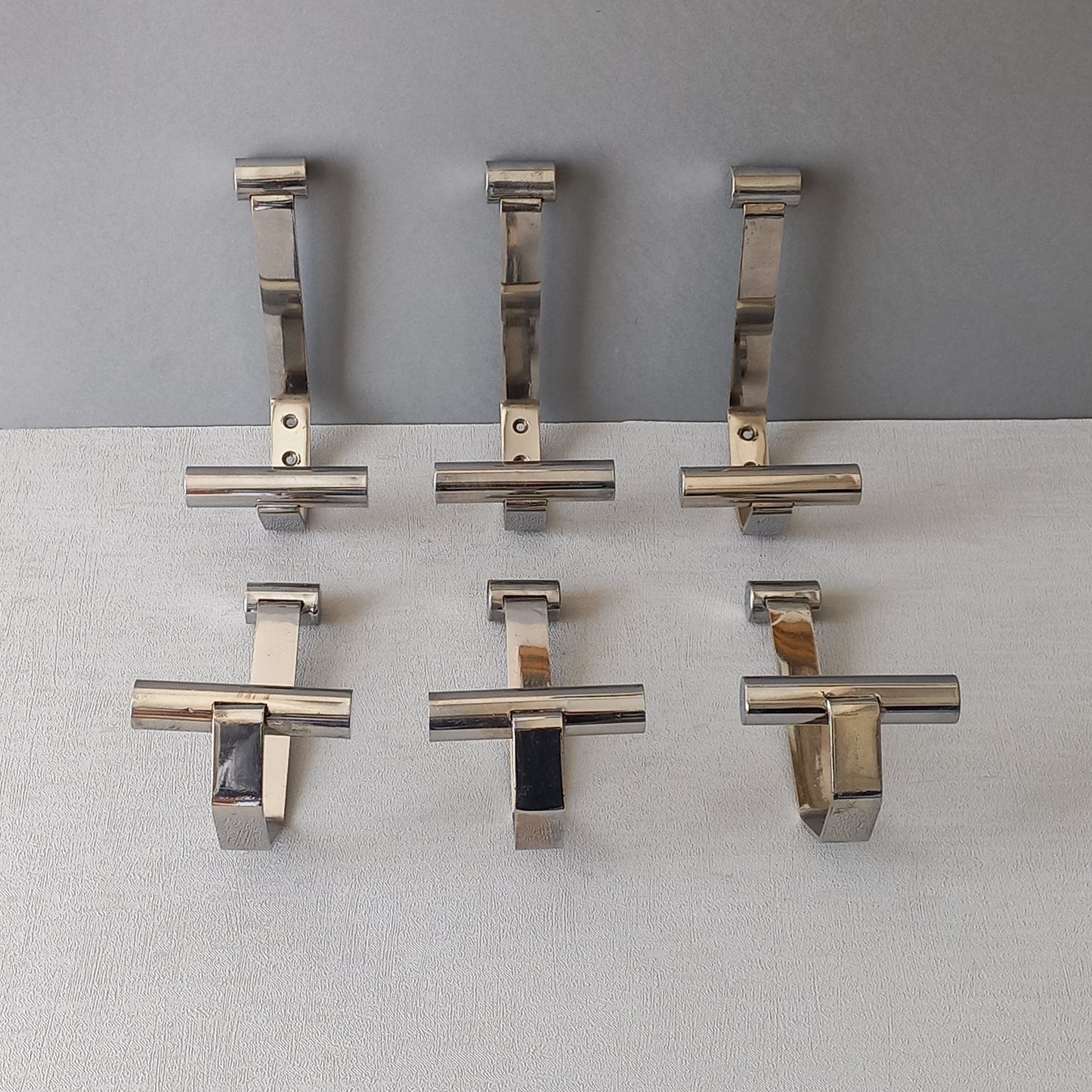 Set of 6 French vintage mid-century coat and hat hooks made from polished metal that can be simply fitted to your wall using the mounting holes.
