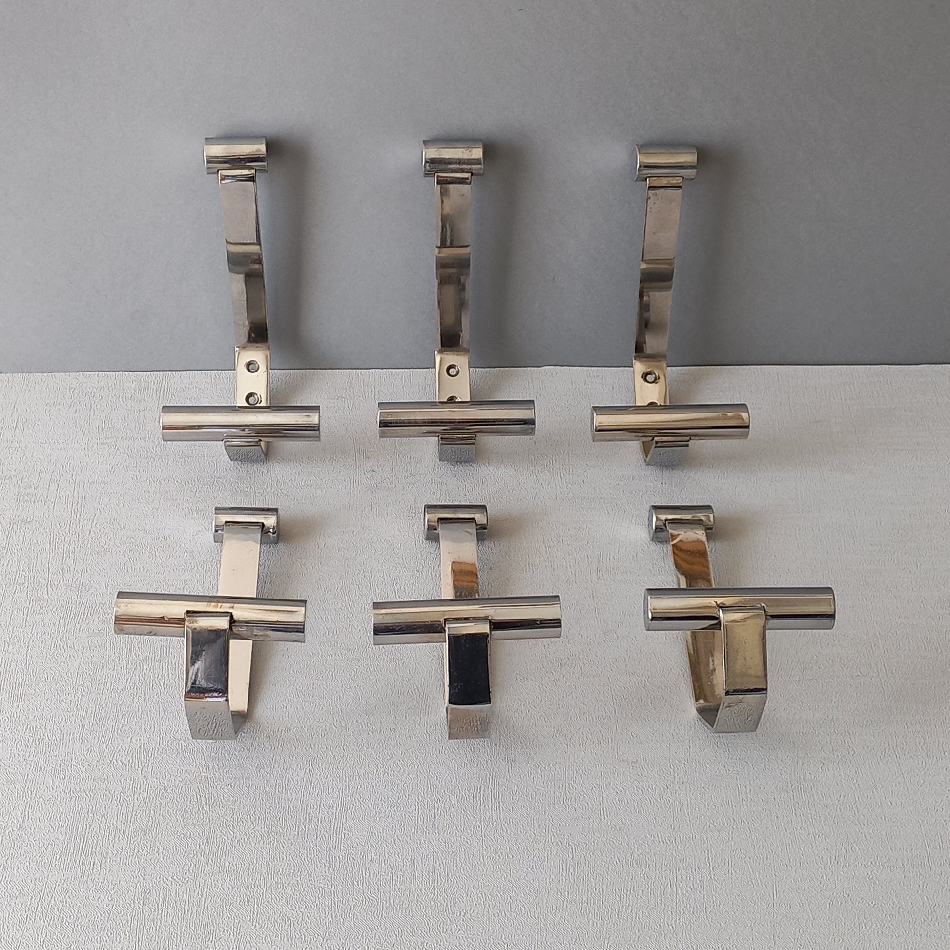 Set of 6 French vintage mid-century coat and hat hooks made from polished metal that can be simply fitted to your wall using the mounting holes.