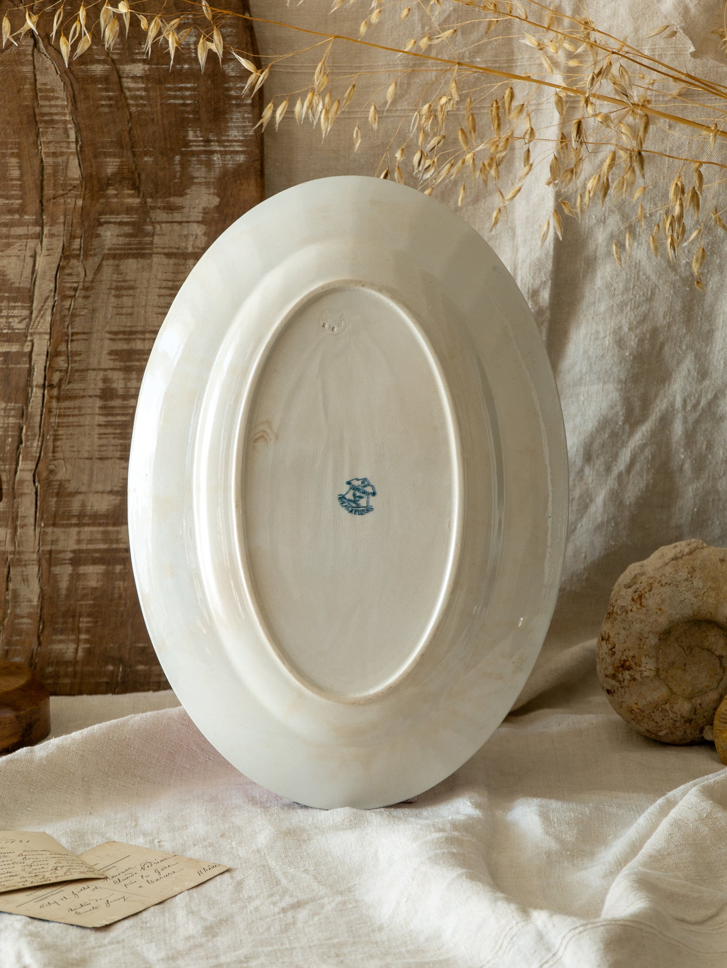An absolutely stunning large French antique oval ironstone serving plate in a delightful time-worn creamy white with blue transferware pattern depicting two cute birds and flowers. 