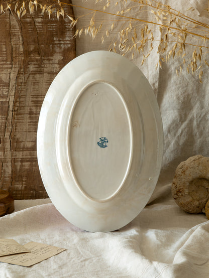 An absolutely stunning large French antique oval ironstone serving plate in a delightful time-worn creamy white with blue transferware pattern depicting two cute birds and flowers. 