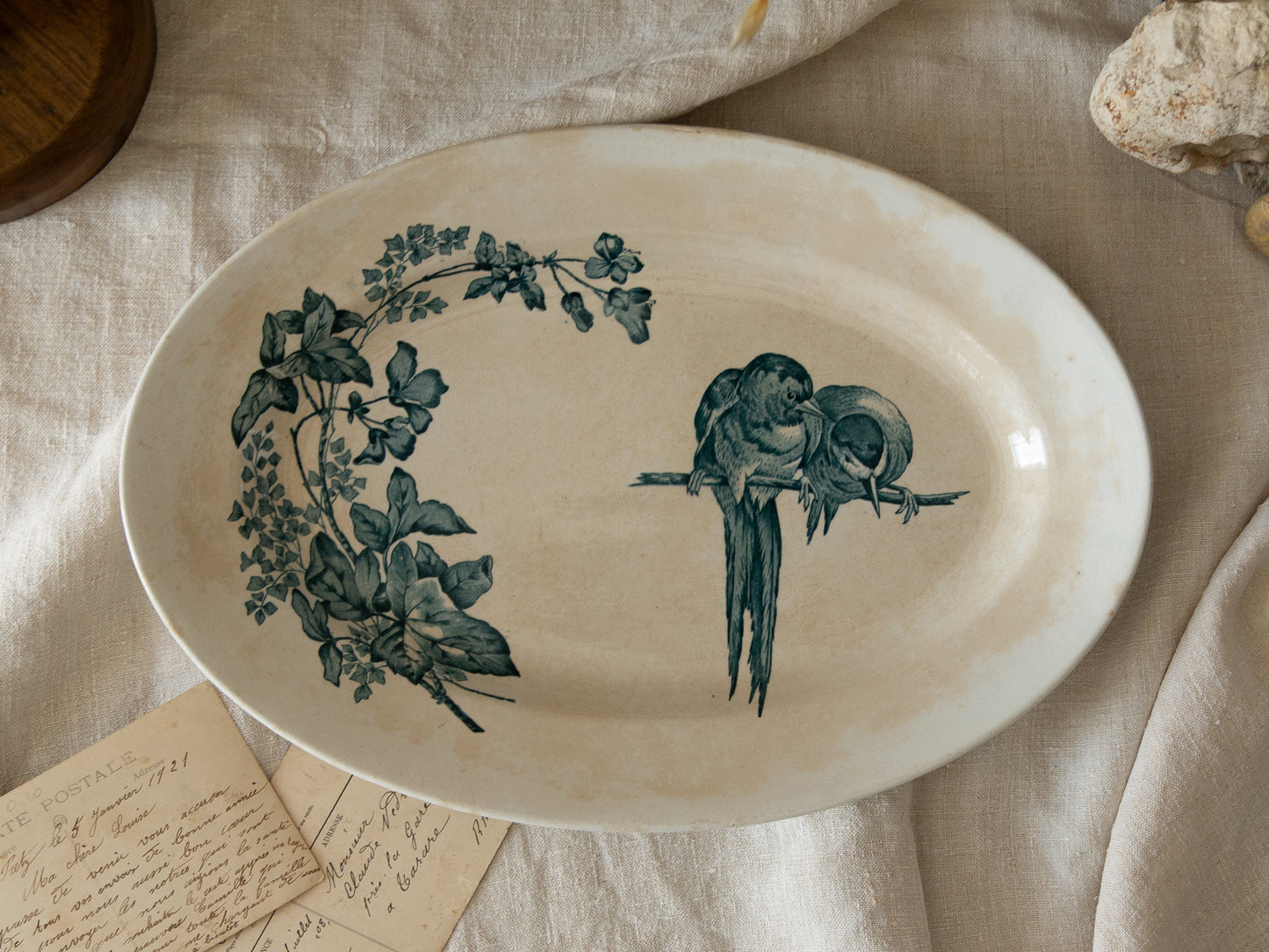 An absolutely stunning large French antique oval ironstone serving plate in a delightful time-worn creamy white with blue transferware pattern depicting two cute birds and flowers. 
