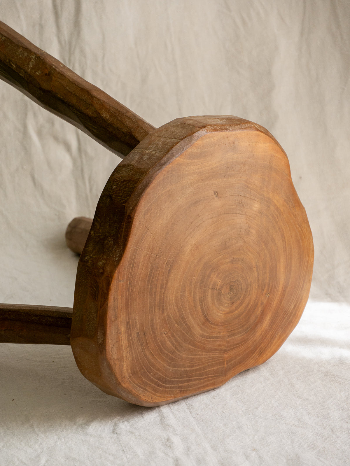 A French vintage chunky three legged wooden stool, a rustic piece with a lovely thick wooden seat that shows the natural pattern of the wood beautifully.