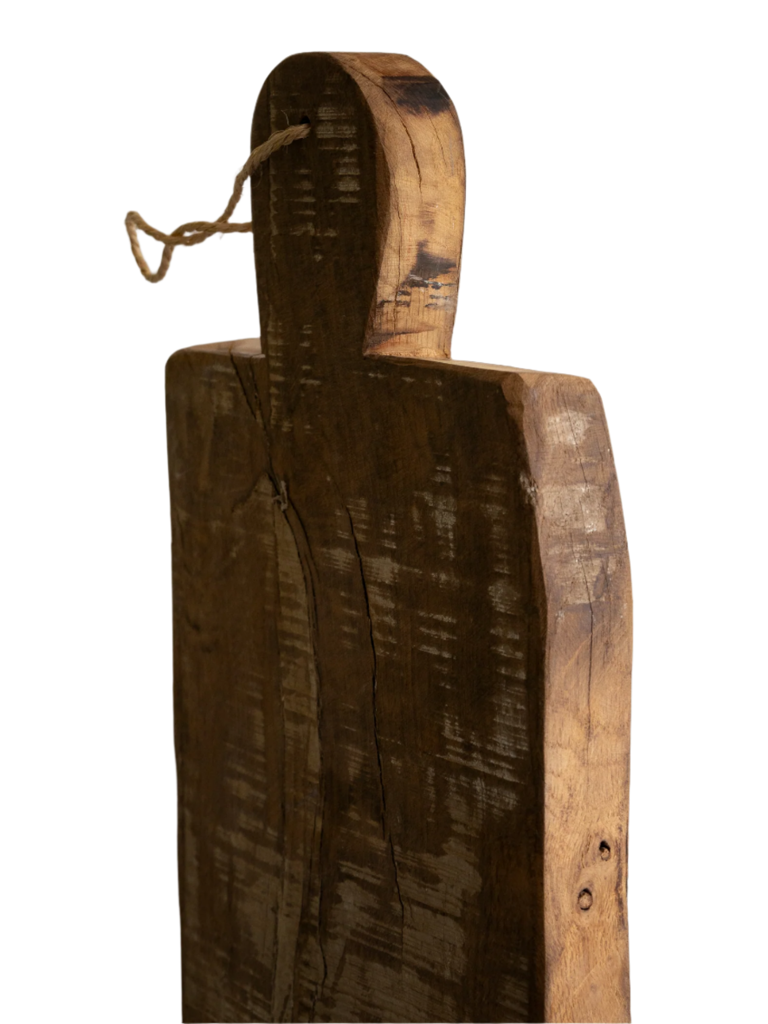 A large vintage wooden chopping board from south west France, shaped by years of use and hand-worn edges. Its rough texture and deep patina tell the story of daily bread, shared meals, and time well lived.