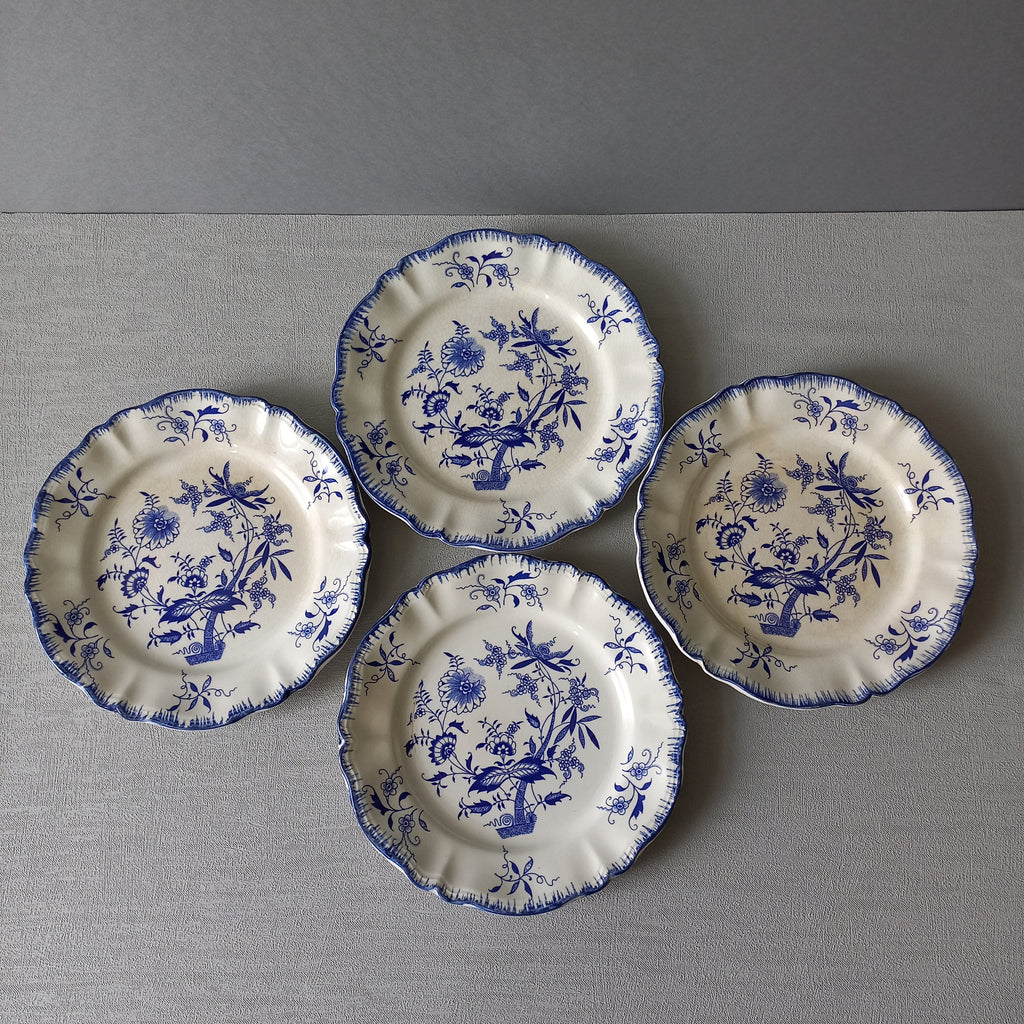 A stunning set of 4 small antique white ironstone plates with blue floral patterns from France.