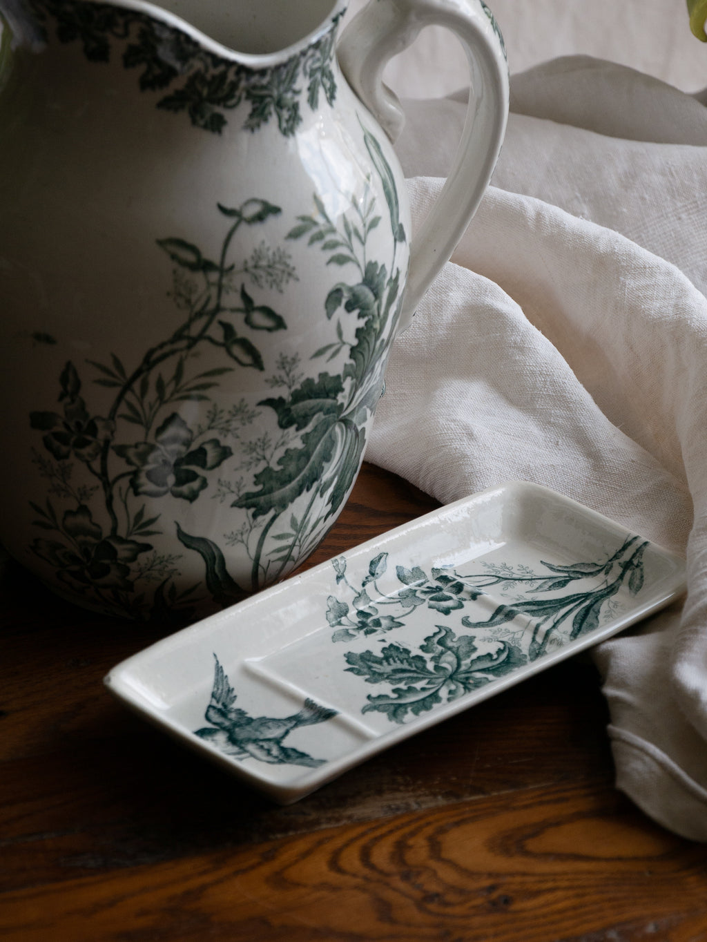 A French antique ironstone jug, basin and soap dish, printed in a soft teal-green bird-and-floral pattern. 