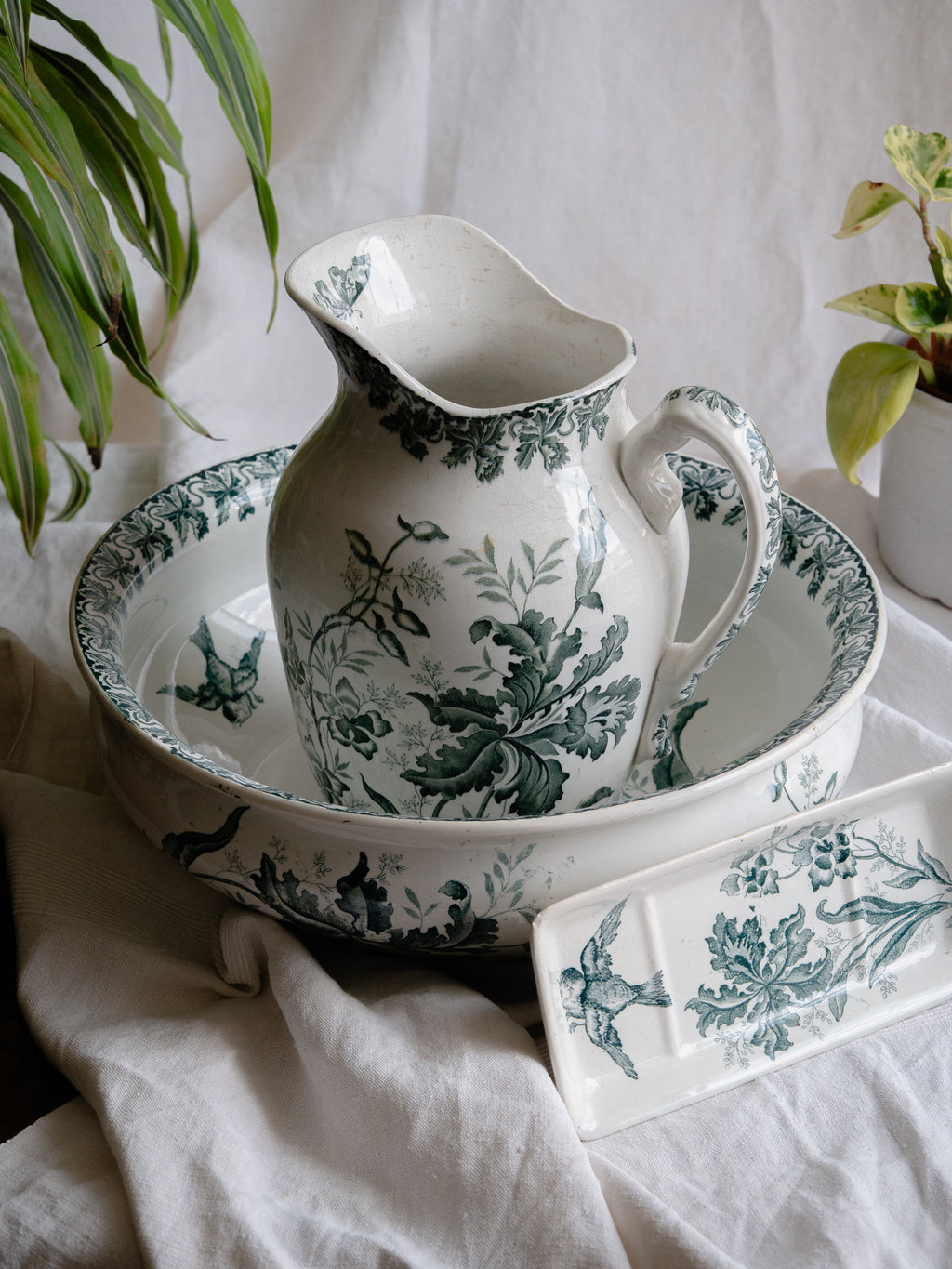A French antique ironstone jug, basin and soap dish, printed in a soft teal-green bird-and-floral pattern. 