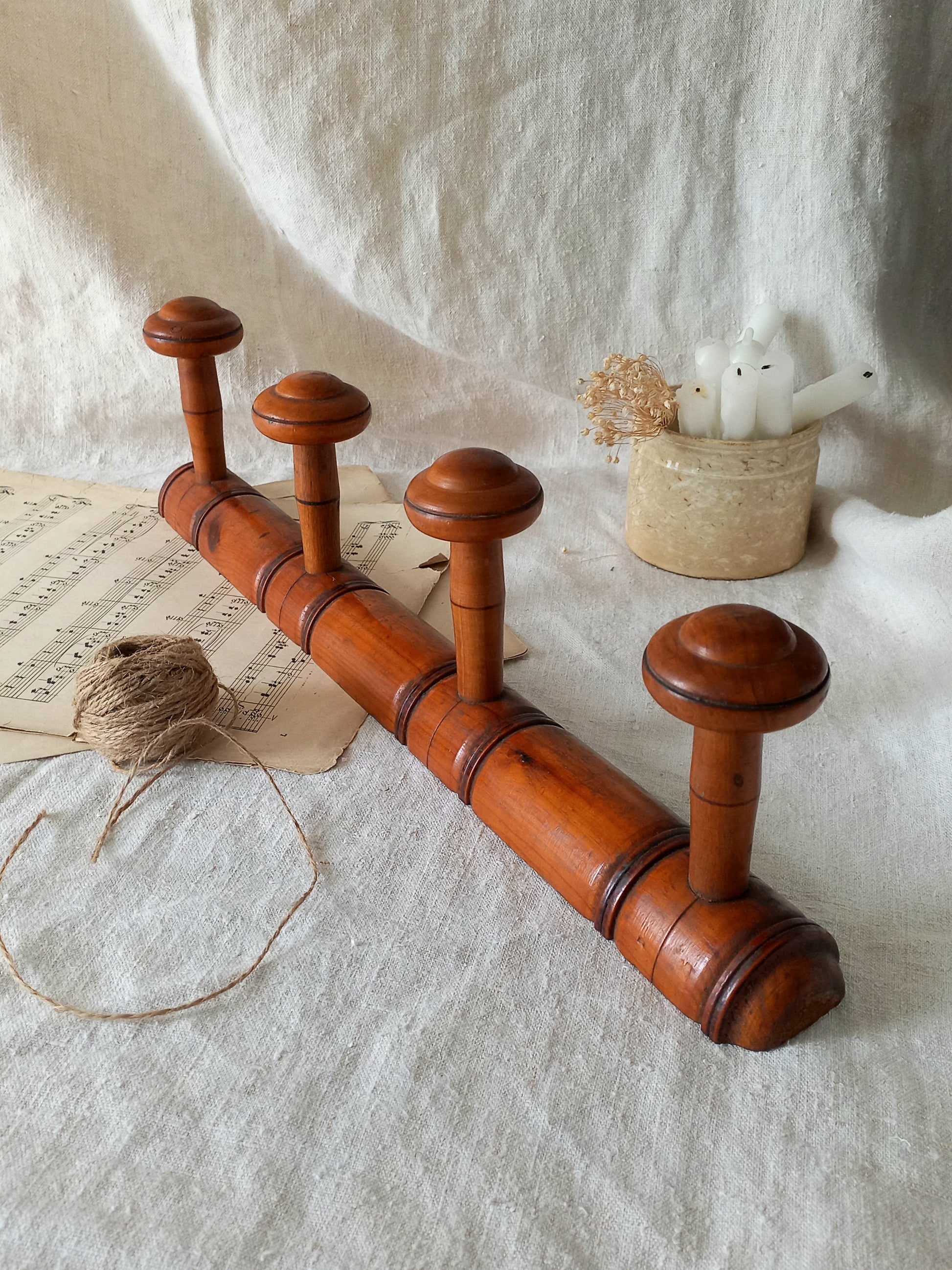 French Antique Faux Bamboo Coat Rack with Four Pegs in rustic setting.