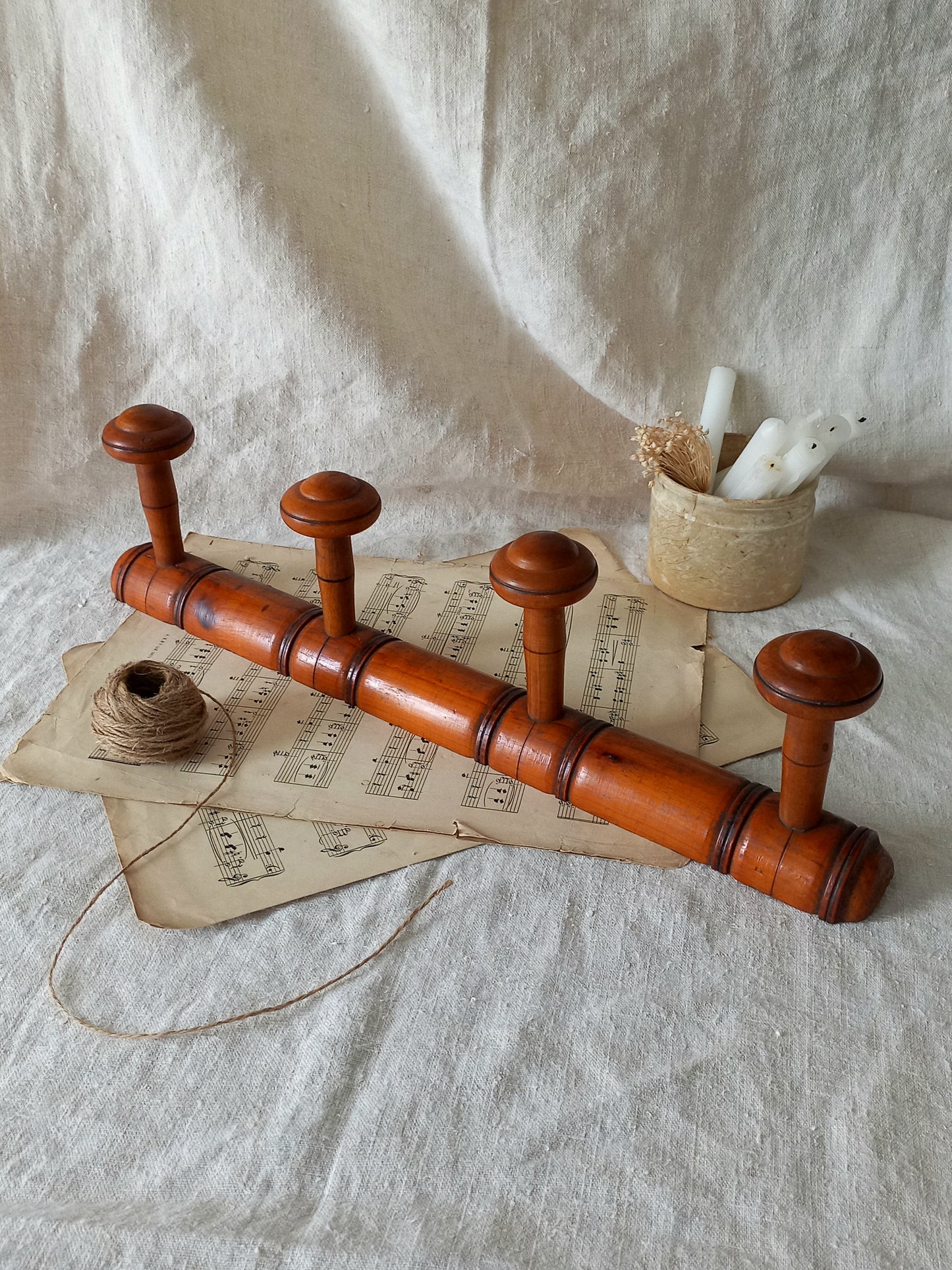 French Antique Faux Bamboo Coat Rack with Four Pegs in rustic setting.