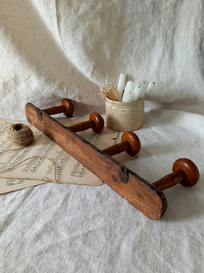 Rear of French Antique Faux Bamboo Coat Rack with Four Pegs in rustic setting.