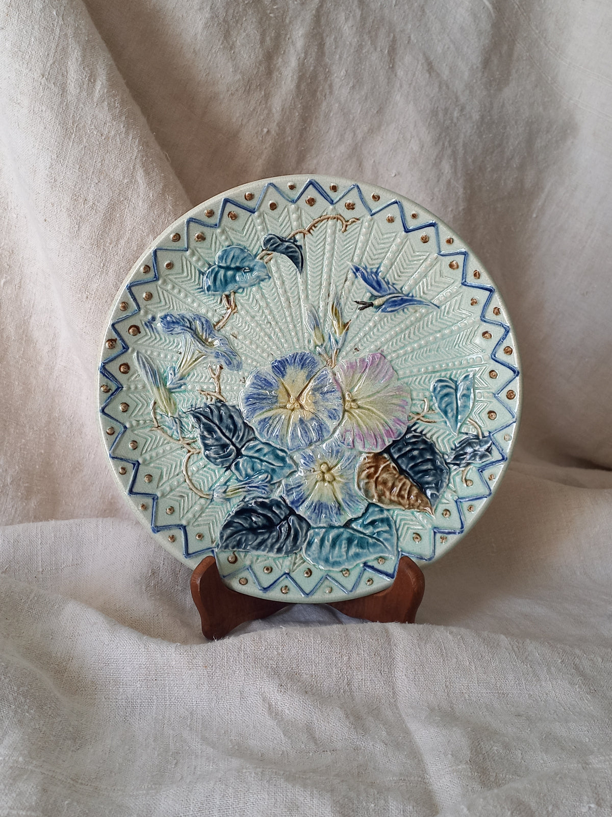 Antique Wasmuel blue floral majolica plate with designs in relief.