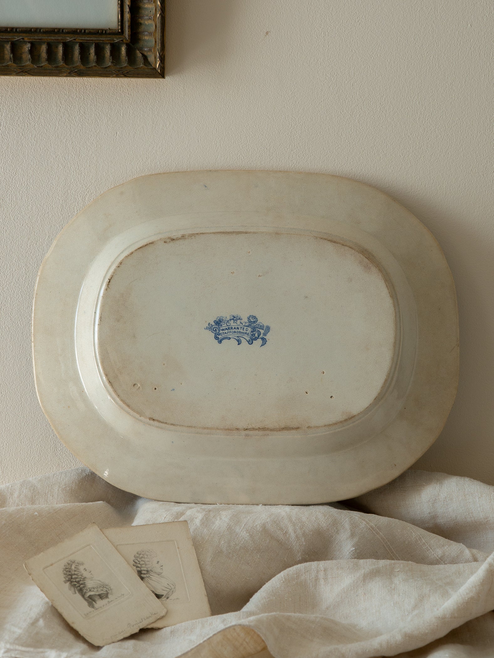 Vintage oval platter with blue floral design on a white surface