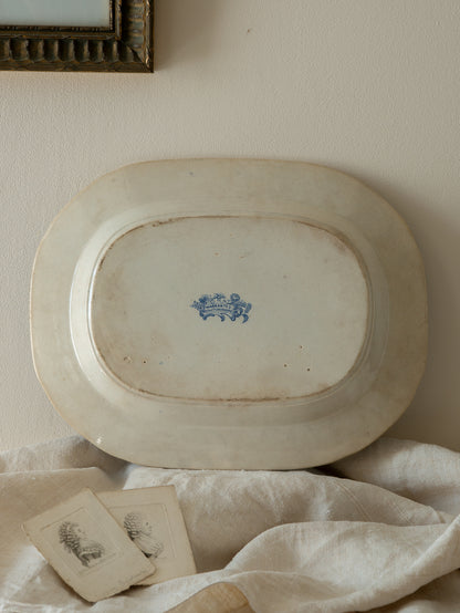 Vintage oval platter with blue floral design on a white surface