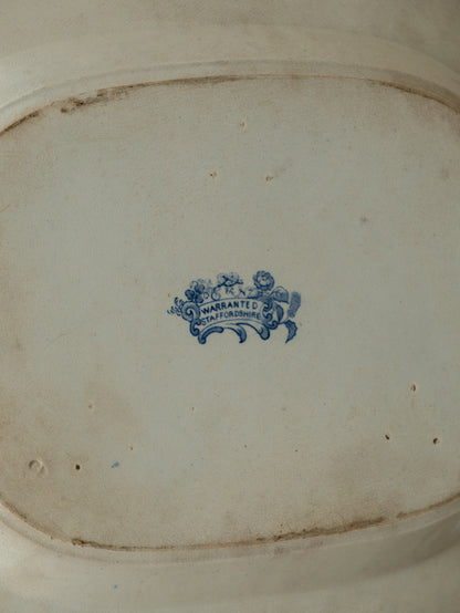 Close-up of a ceramic dish with a blue logo and text on a white background