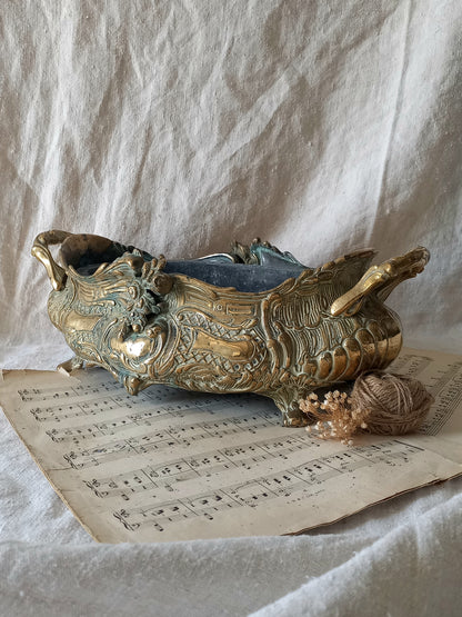 French art nouveau decorative brass planter in a decorative setting.