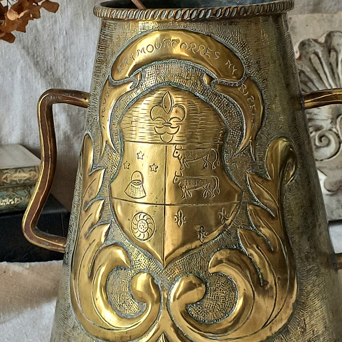 A decorative vintage/antique brass vase with a coat of arms - an unusual piece of brass ware likely a tourist piece inspired by old fountains that were often decorated with a family, commune or regional coat of arms. These days it could have many uses including stand-alone home decor, a decorative vase, or maybe a planter (if considering as a planter the top opening is: 10.7 cm (just over 4'').
