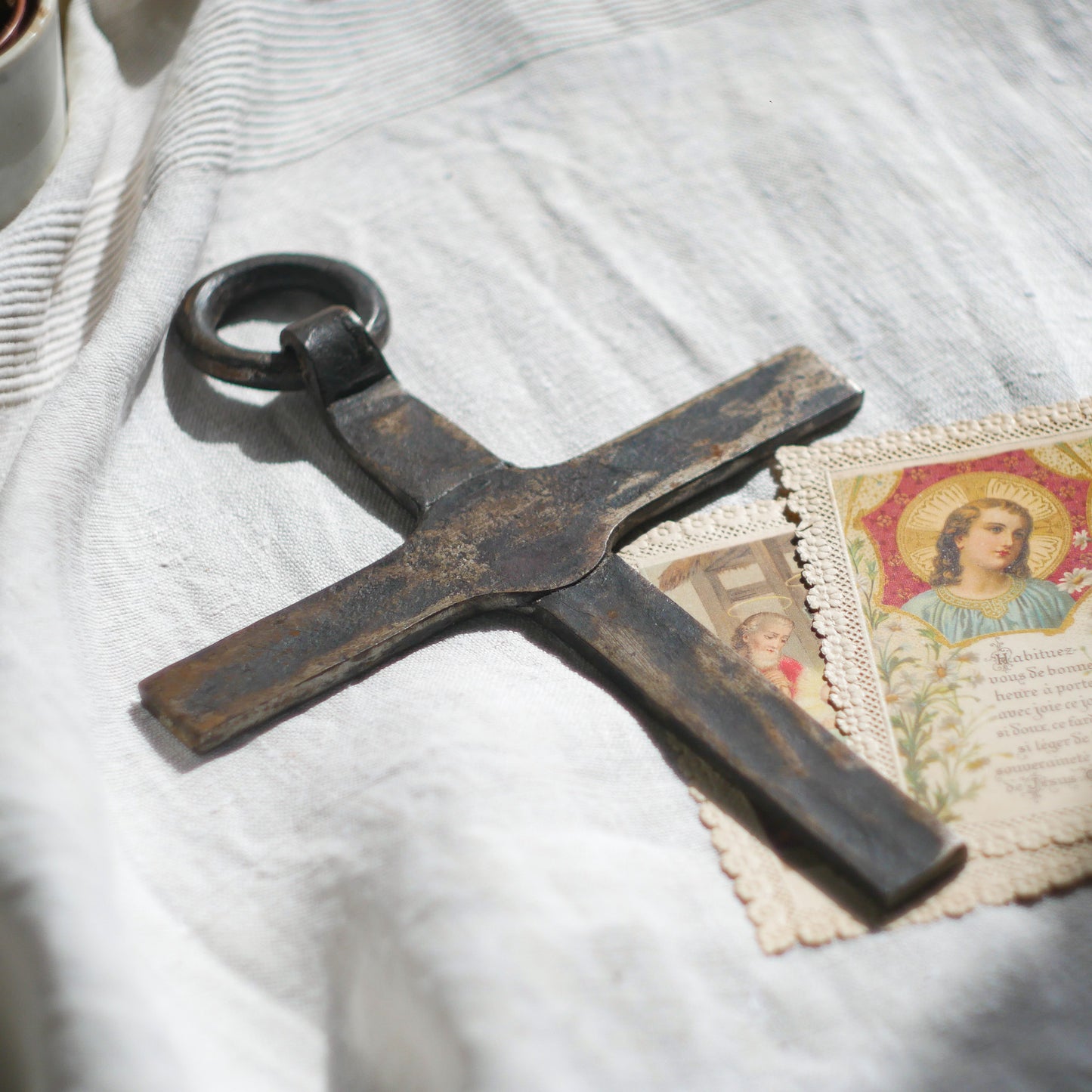An interesting French antique artisan made Crucifix made from iron and painted black. On one side the metal has worn away in places giving this piece a pleasing patina of age. There's a hanging loop so it's ready to hang in your home.

We guesstimate this piece to be over 100 years old.
