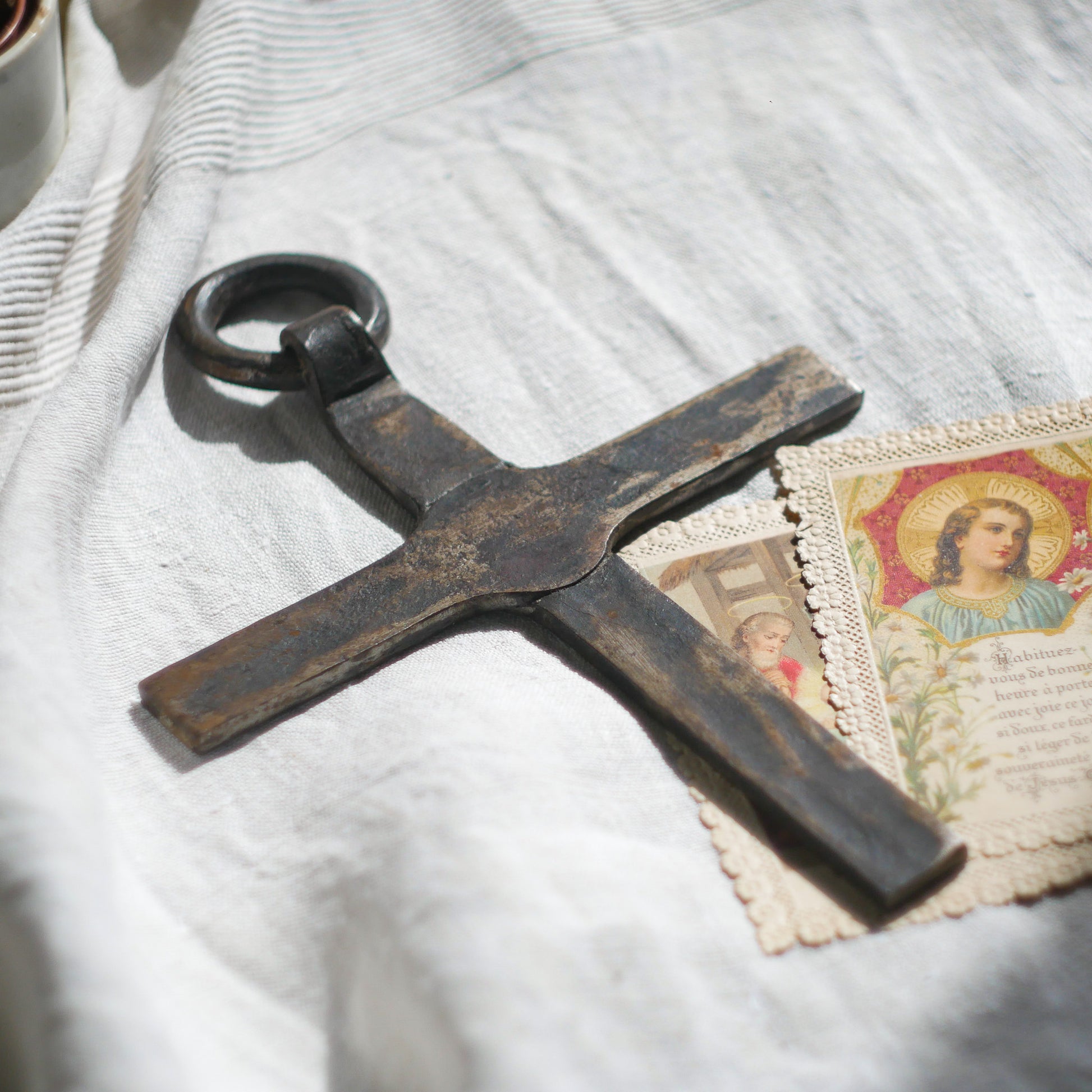 An interesting French antique artisan made Crucifix made from iron and painted black. On one side the metal has worn away in places giving this piece a pleasing patina of age. There's a hanging loop so it's ready to hang in your home.

We guesstimate this piece to be over 100 years old.