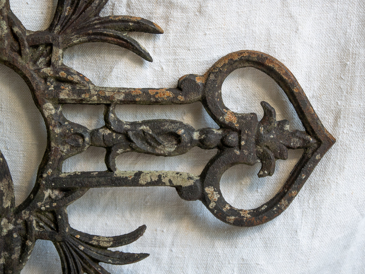 A large French antique crucifix in cast or wrought iron, featuring a figure of the Madonna at its center. Likely once part of a larger architectural structure, this rare piece carries visible signs of age and long exposure to the elements.
