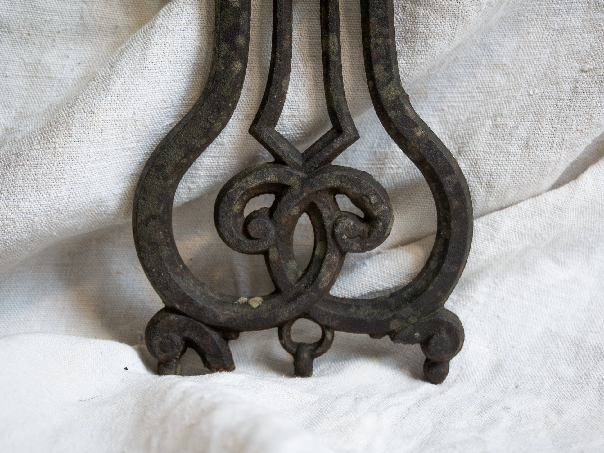 A large French antique crucifix in cast or wrought iron, featuring a figure of the Madonna at its center. Likely once part of a larger architectural structure, this rare piece carries visible signs of age and long exposure to the elements.