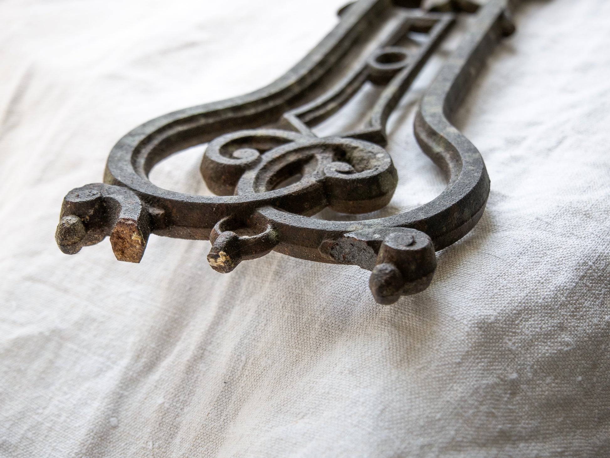 A large French antique crucifix in cast or wrought iron, featuring a figure of the Madonna at its center. Likely once part of a larger architectural structure, this rare piece carries visible signs of age and long exposure to the elements.