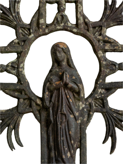 A large French antique crucifix in cast or wrought iron, featuring a figure of the Madonna at its center. Likely once part of a larger architectural structure, this rare piece carries visible signs of age and long exposure to the elements.