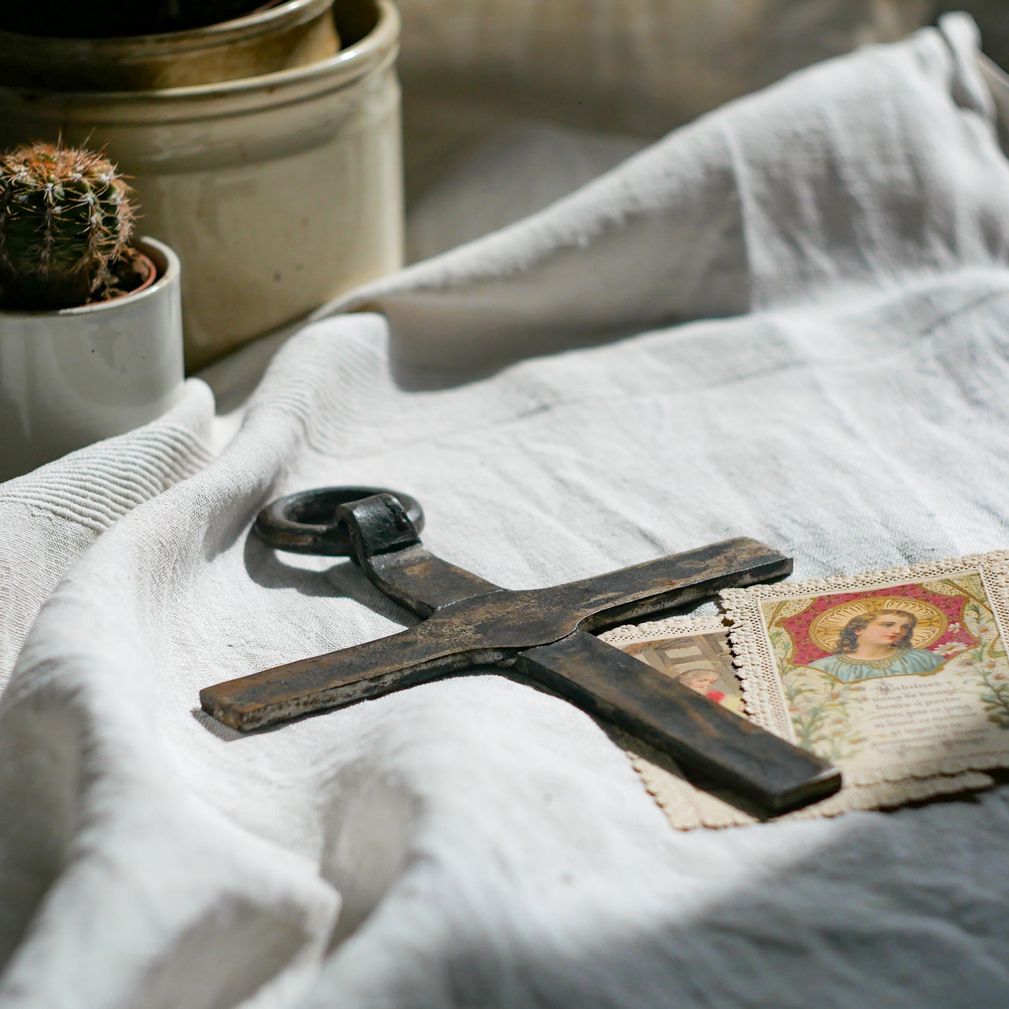 An interesting French antique artisan made Crucifix made from iron and painted black. On one side the metal has worn away in places giving this piece a pleasing patina of age. There's a hanging loop so it's ready to hang in your home.

We guesstimate this piece to be over 100 years old.