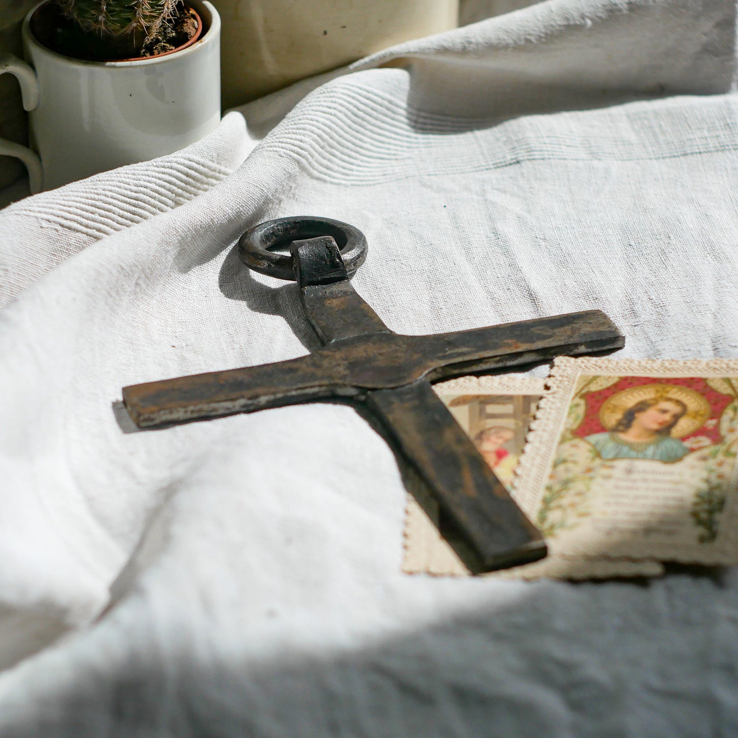 An interesting French antique artisan made Crucifix made from iron and painted black. On one side the metal has worn away in places giving this piece a pleasing patina of age. There's a hanging loop so it's ready to hang in your home.

We guesstimate this piece to be over 100 years old.